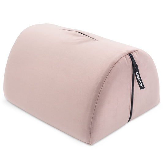 Pink wedge pillow with a brand label on a white background
